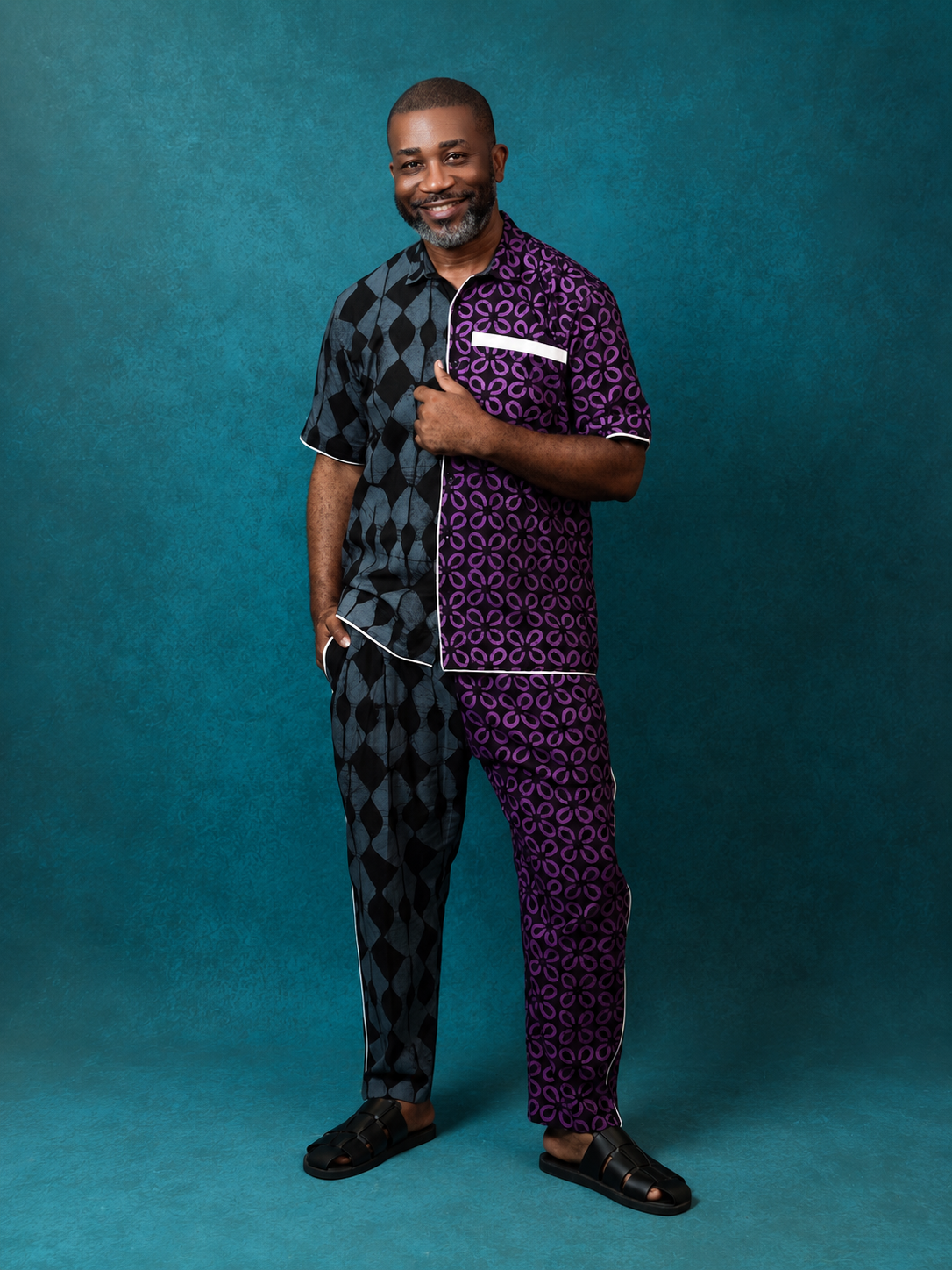 Model wearing an OBIDA half-and-half black and purple patterned set against a teal studio backdrop.
